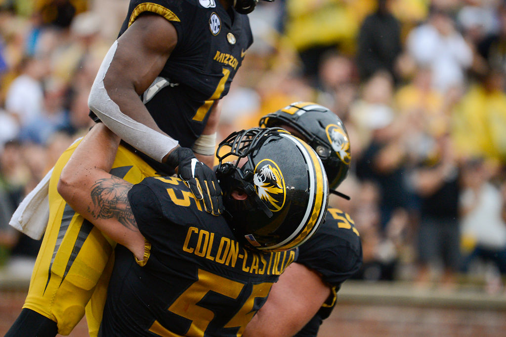 Missouri Center Trystan Colon-Castillo hoists RB Tyler Badie